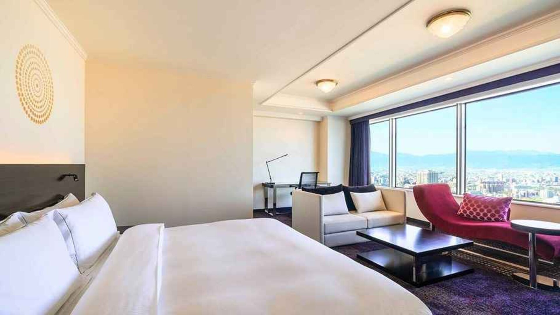 luxurious king suite with lounge area, business desk, and chair at Hilton Fukuoka Sea Hawk.