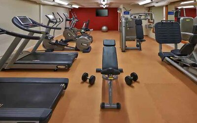 Fitness center with treadmills and machines at the Hilton Zurich Airport.