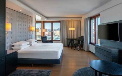 Spacious king suite with desk at the Hilton Stockholm Slussen.