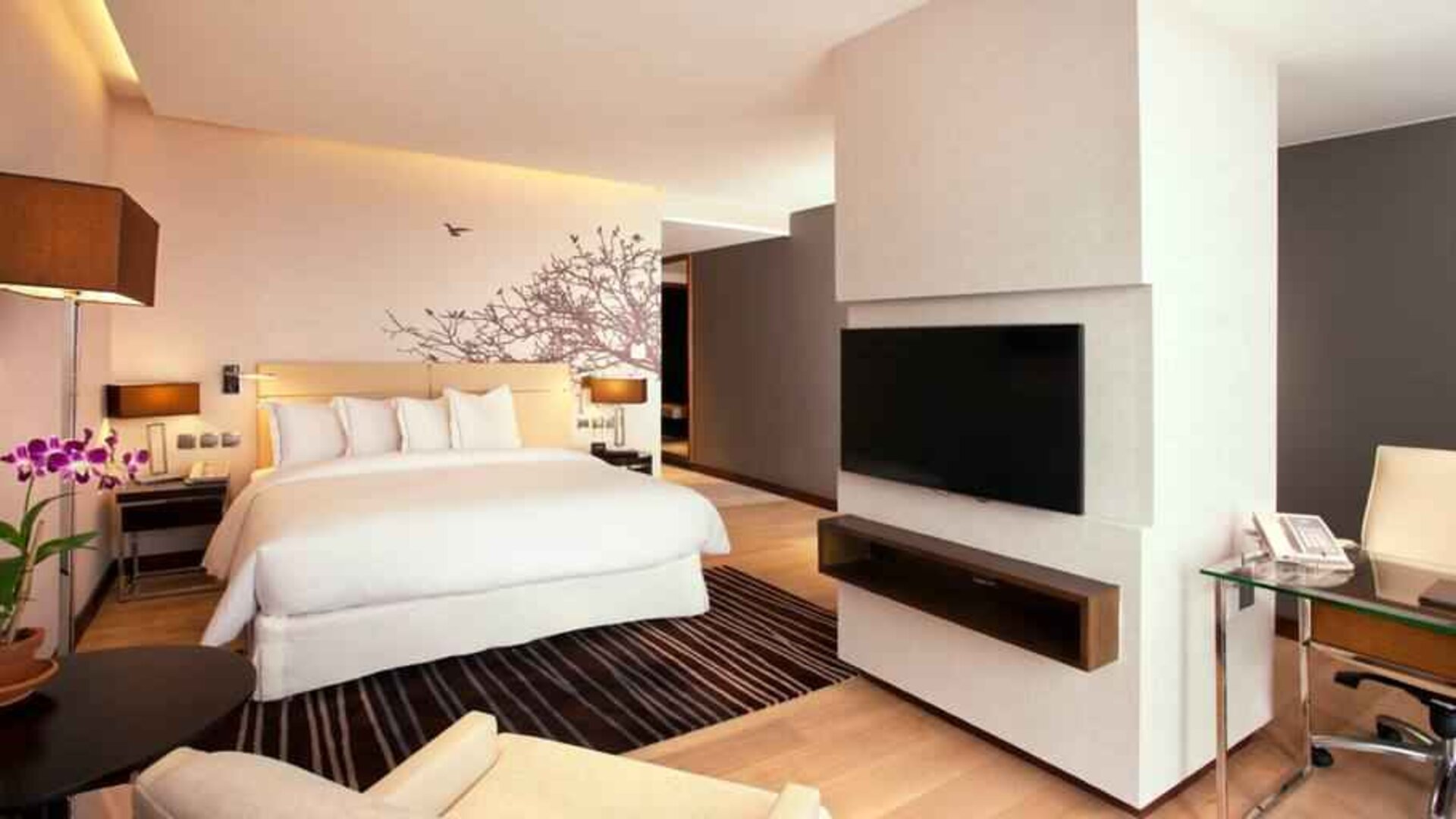 Spacious king bedroom with desk and TV screen at the Hilton Colombo Residence.