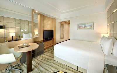 comfortable king room with TV, desk, and chair at DoubleTree by Hilton Riyadh - Al Muroj Business Gate.