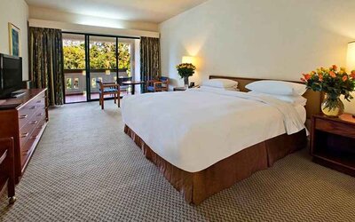 lovely king bedroom with TV and outdoor terrace at Hilton Addis Ababa.