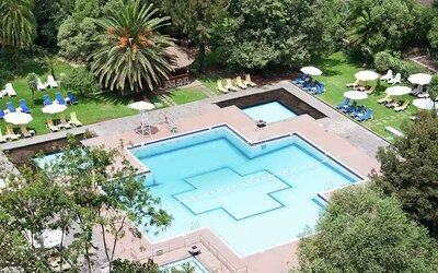 stunning outdoor pool with sun beds and umbrellas at Hilton Addis Ababa.