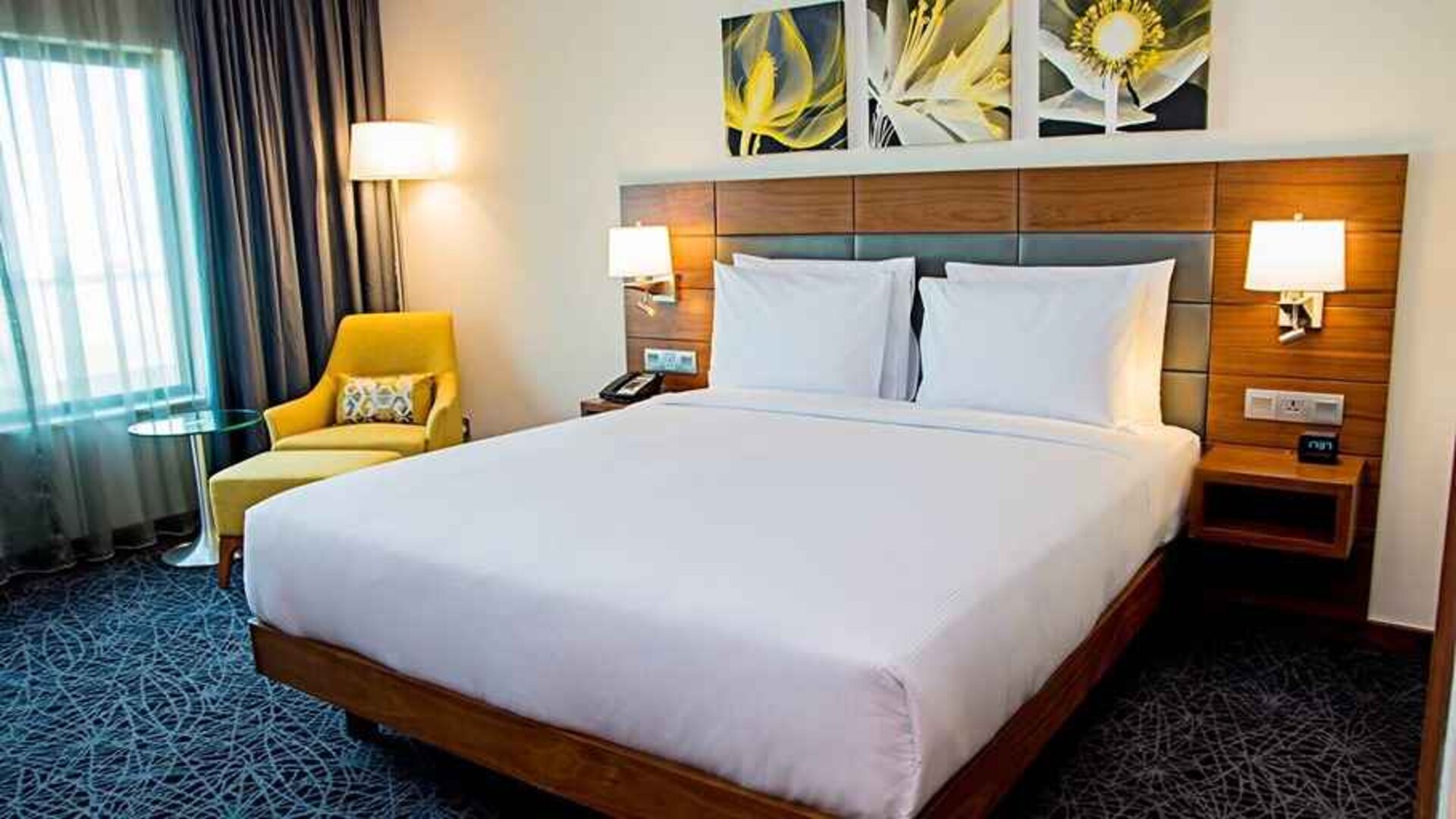 comfortable king room with couch and lots of natural light at Hilton Garden Inn Nairobi Airport.