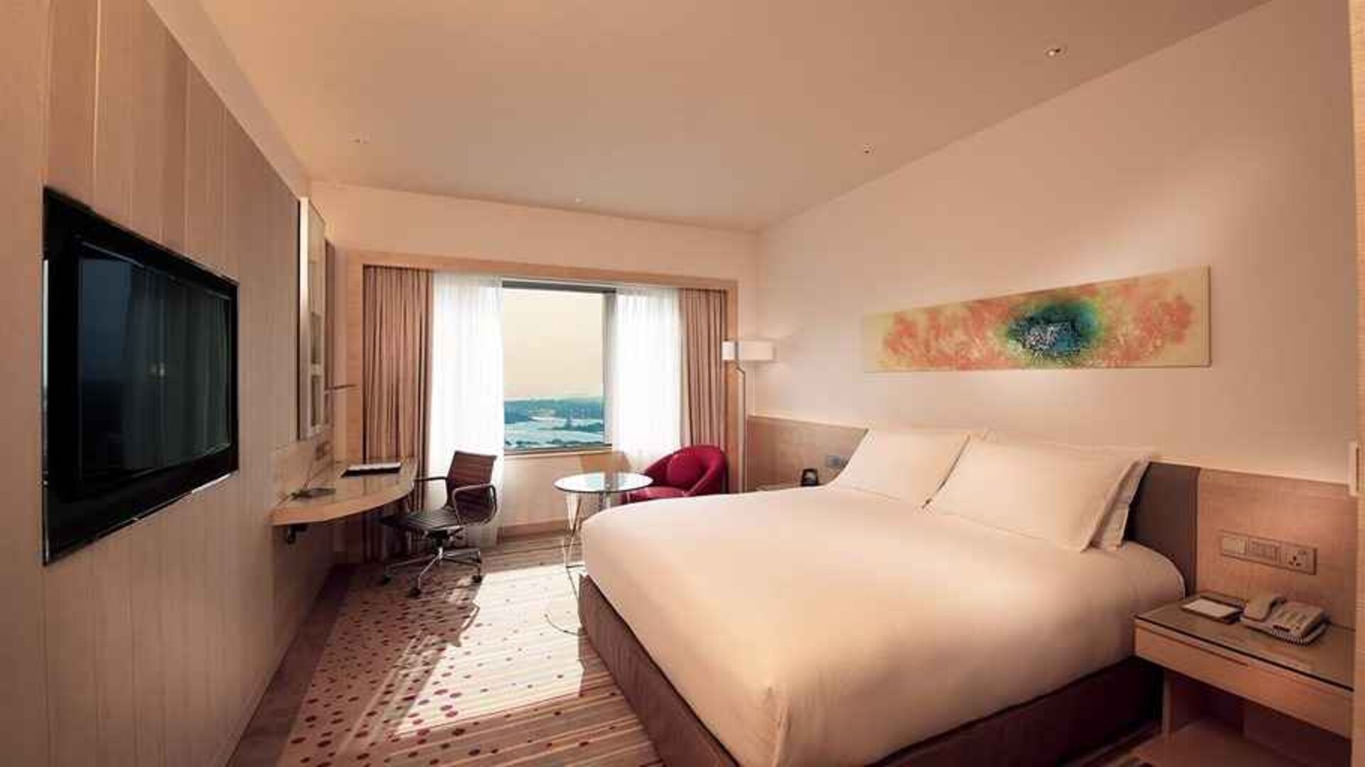 spacious king room with TV, work desk, and chair at DoubleTree by Hilton Hotel Johor Bahru.
