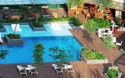 stunning outdoor pool surrounded by sun beds and seating area at DoubleTree by Hilton Hotel Johor Bahru.