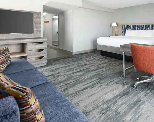 luxurious king suite with lounge and work area at Hampton Inn & Suites Tampa-Ybor City/Downtown.