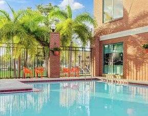 relaxing outdoor pool with seating area at Hampton Inn & Suites Tampa-Ybor City/Downtown.