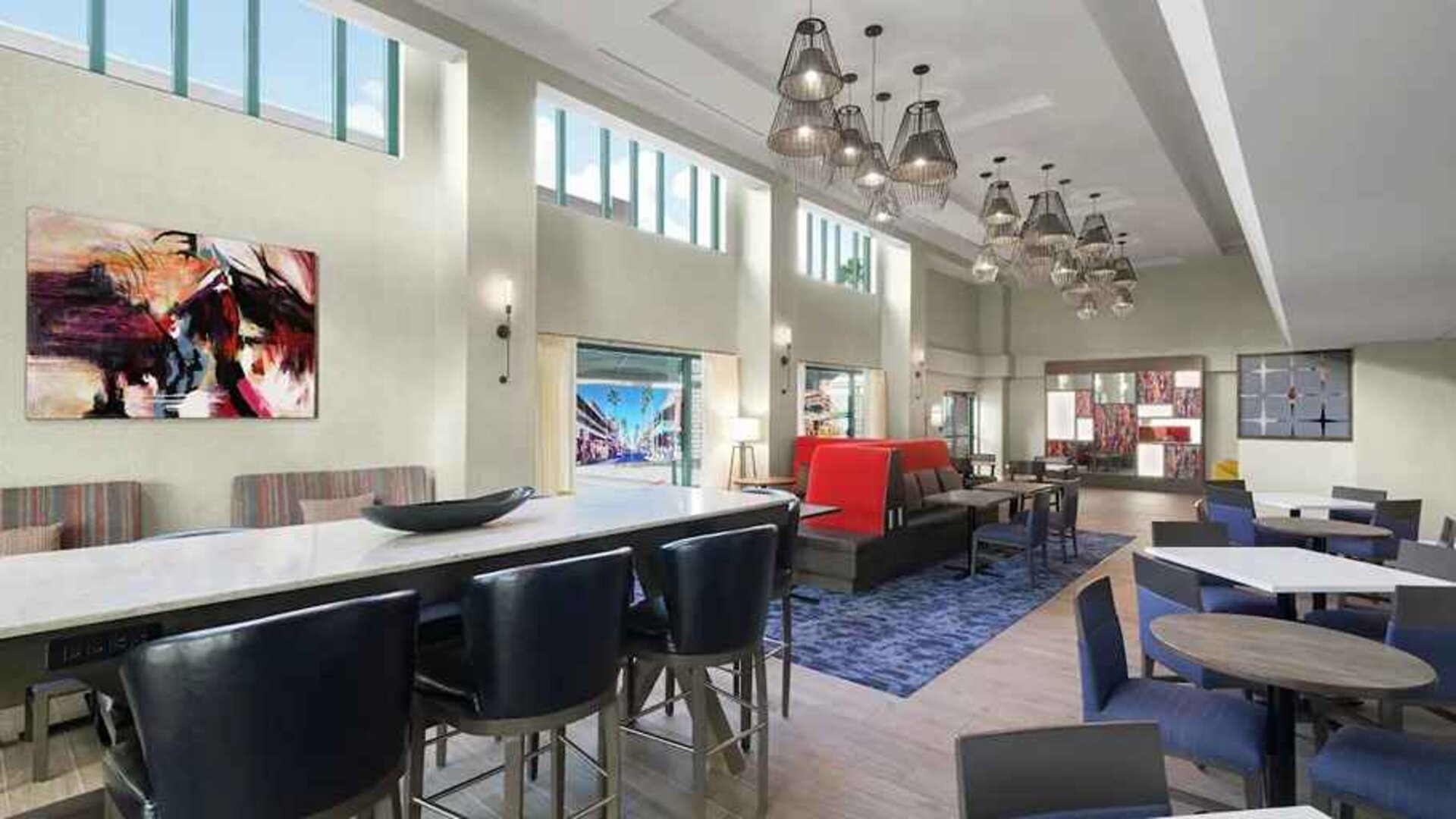 spacious lounge, lobby, coworking space with lots of natural light ideal for doing work online at Hampton Inn & Suites Tampa-Ybor City/Downtown.
