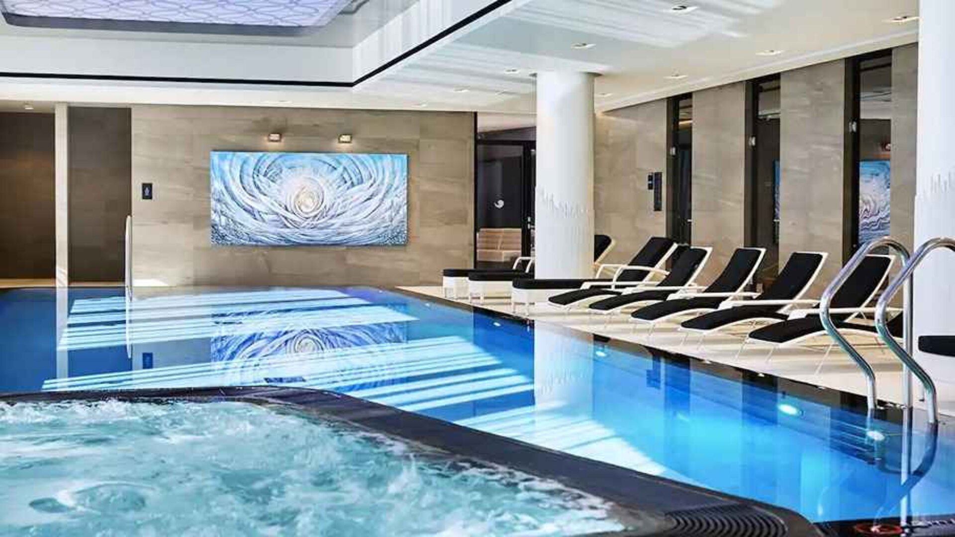 stunning indoor pool with sunbeds at Hilton Tallinn Park.