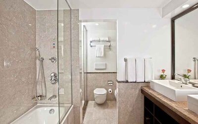 clean and spacious king bathroom with shower and bath at Hilton Cairo Heliopolis.