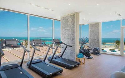 well equipped fitness center with ocean views at Hilton Hurghada Plaza.
