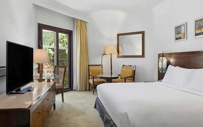 delux king room with TV and dining area at Hilton Luxor Resort & Spa.