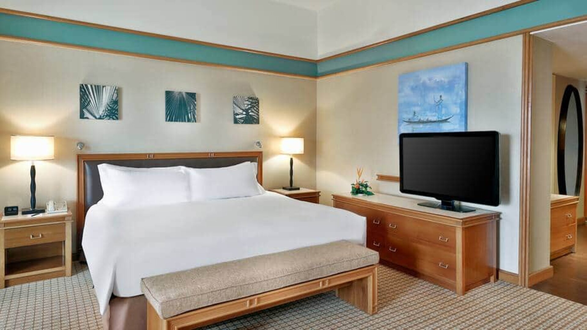 Queen room with chairs, desk and sliding doors at the Hilton Yaounde.