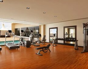 Exercise room with treadmills, free weights, weigth machines, and plenty of space to stretch out and do yoga.