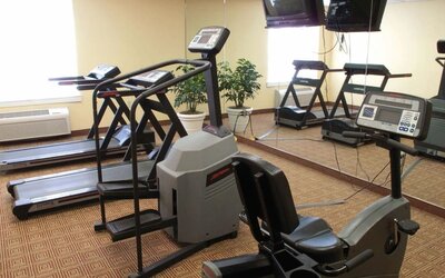 Well-equipped gym featuring treadmills, exercise equipment, and fitness amenities available for guest use at La Quinta Inn & Suites By Wyndham Sawgrass Mills.