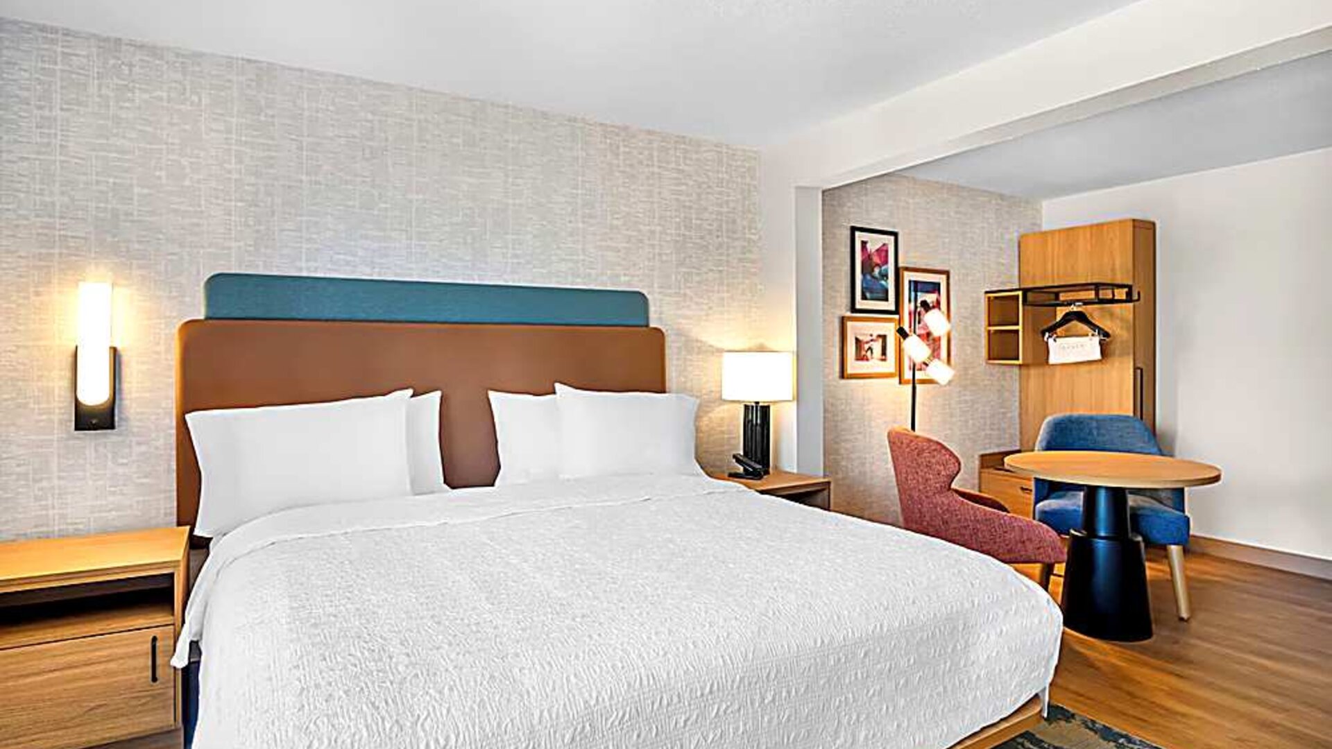 Romantic king bed with seating area Spacious king room with chair and table and TV. 