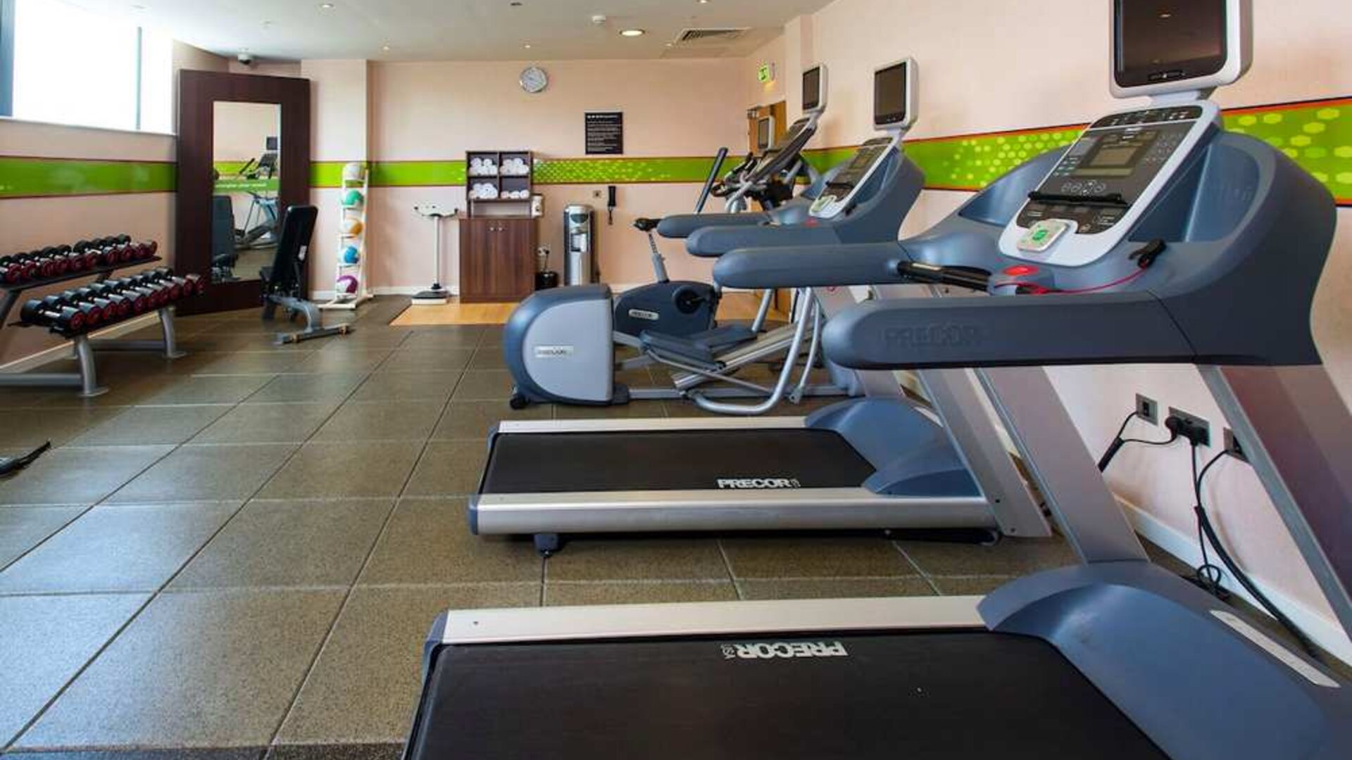 Fitness center well equipped with treadmills and step machines. 
