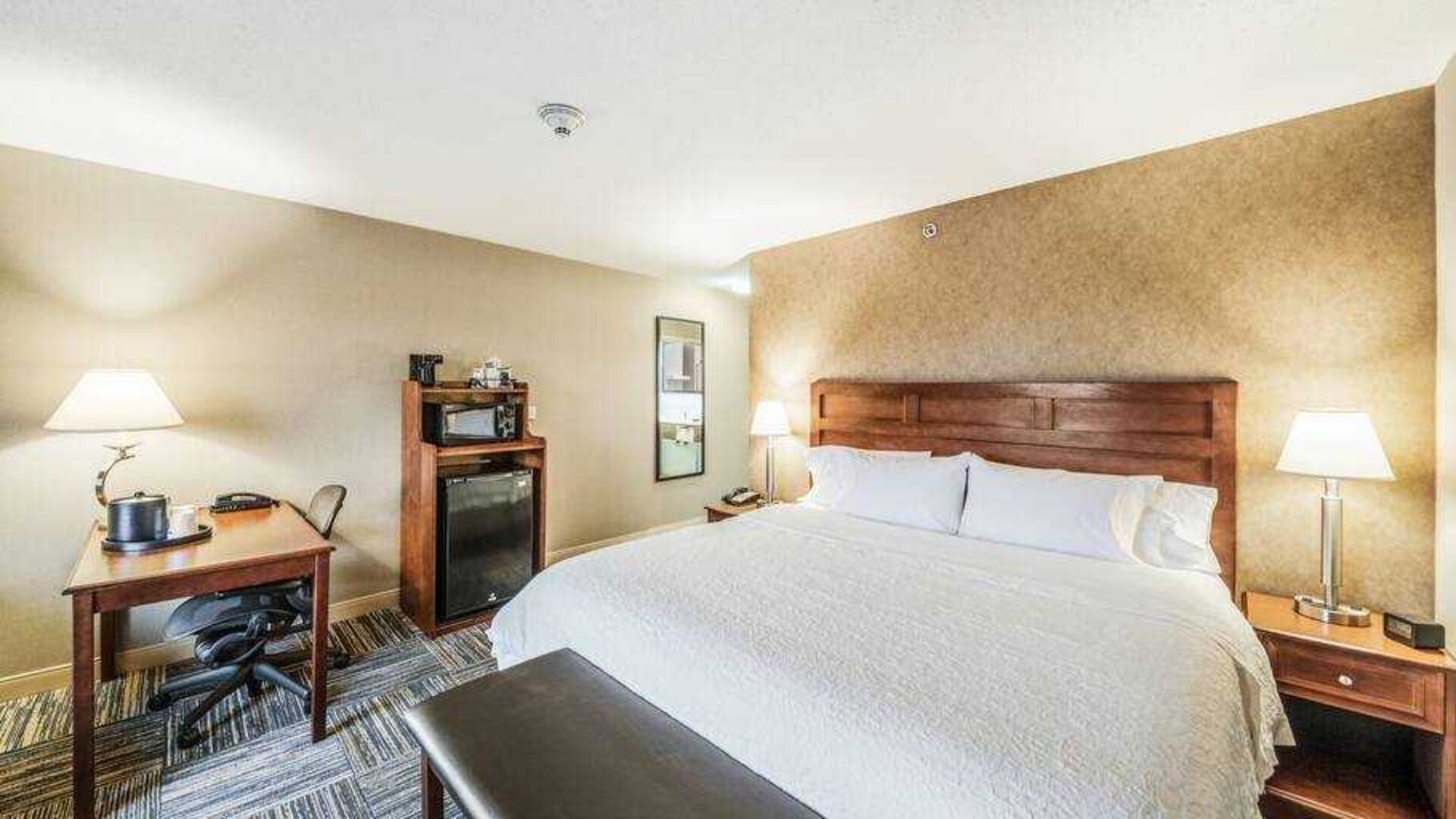 King bedroom with desk at the Hampton Inn Greenfield.