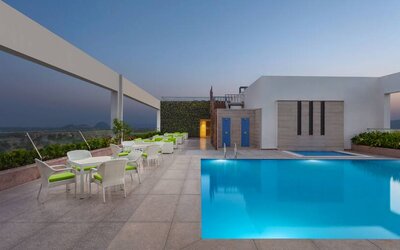 Relaxing outdoor pool area at the DoubleTree by Hilton Jaipur Amer.