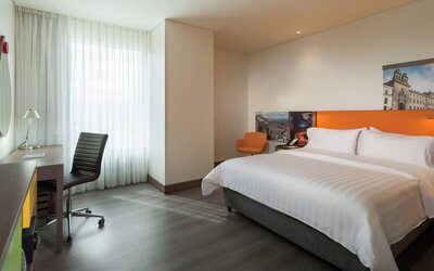 King bedroom with desk at the Hampton by Hilton Bogota Airport.