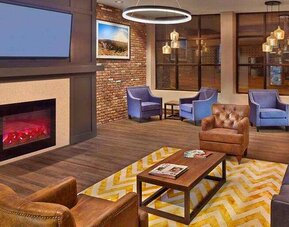 Lobby workspace by the fireplace at the Tapestry By Hilton Scholar Morgantown, WV.