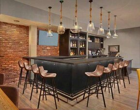 Seating area along the bar at the Tapestry By Hilton Scholar Morgantown, WV.