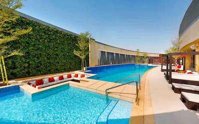 Relaxing outdoor pool at the AlRayyan Hotel Doha, Curio Collection by Hilton.