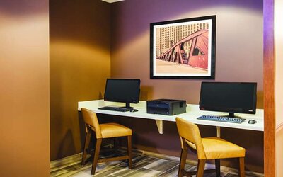 Business center with computers and printer at La Quinta Inn & Suites By Wyndham Chicago Downtown.