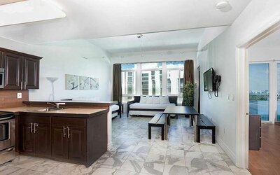 Living room with kitchenette and workspace at New Point Miami.