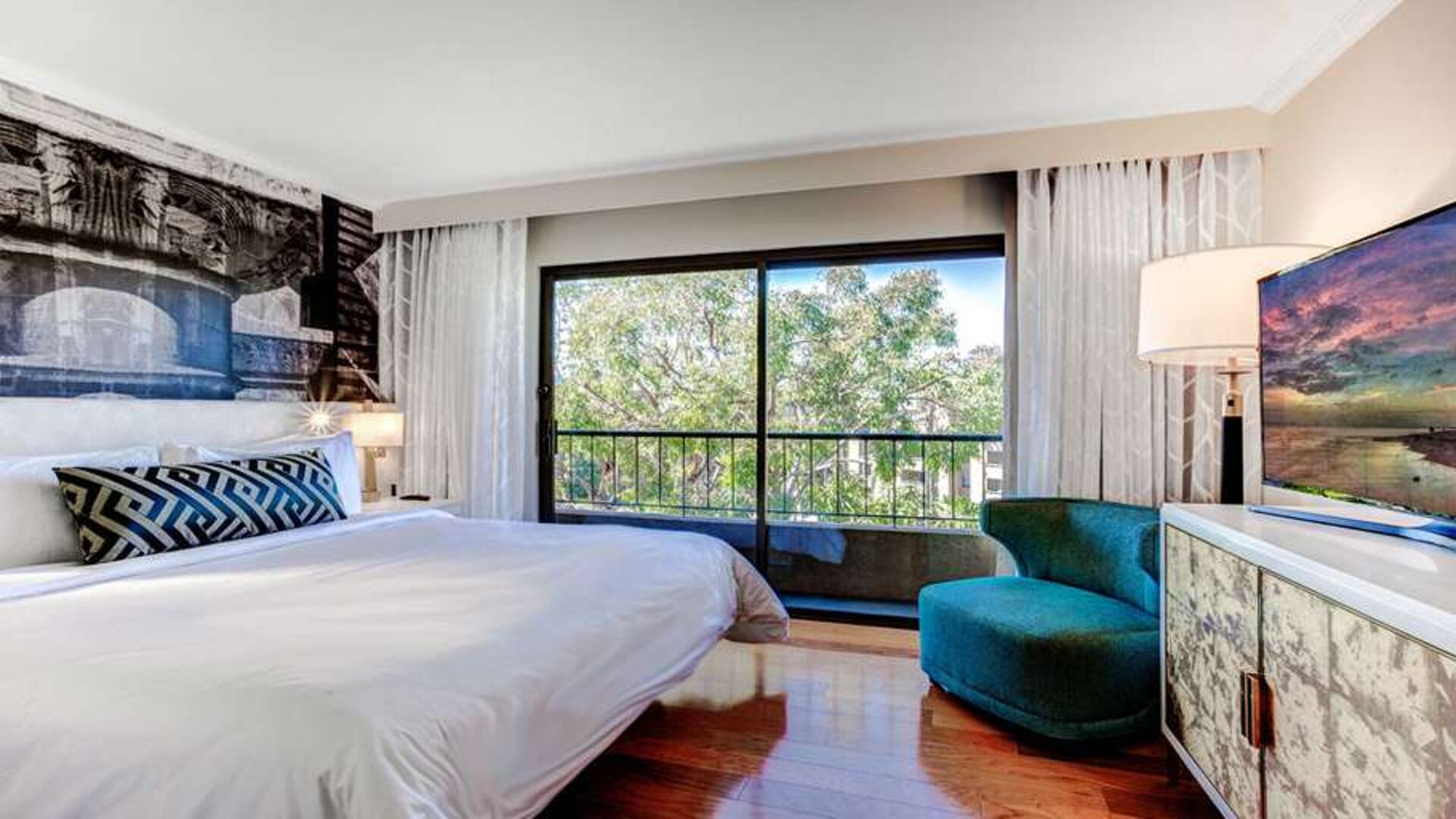 King bedroom with big window at Avenue Of The Arts Hotel.