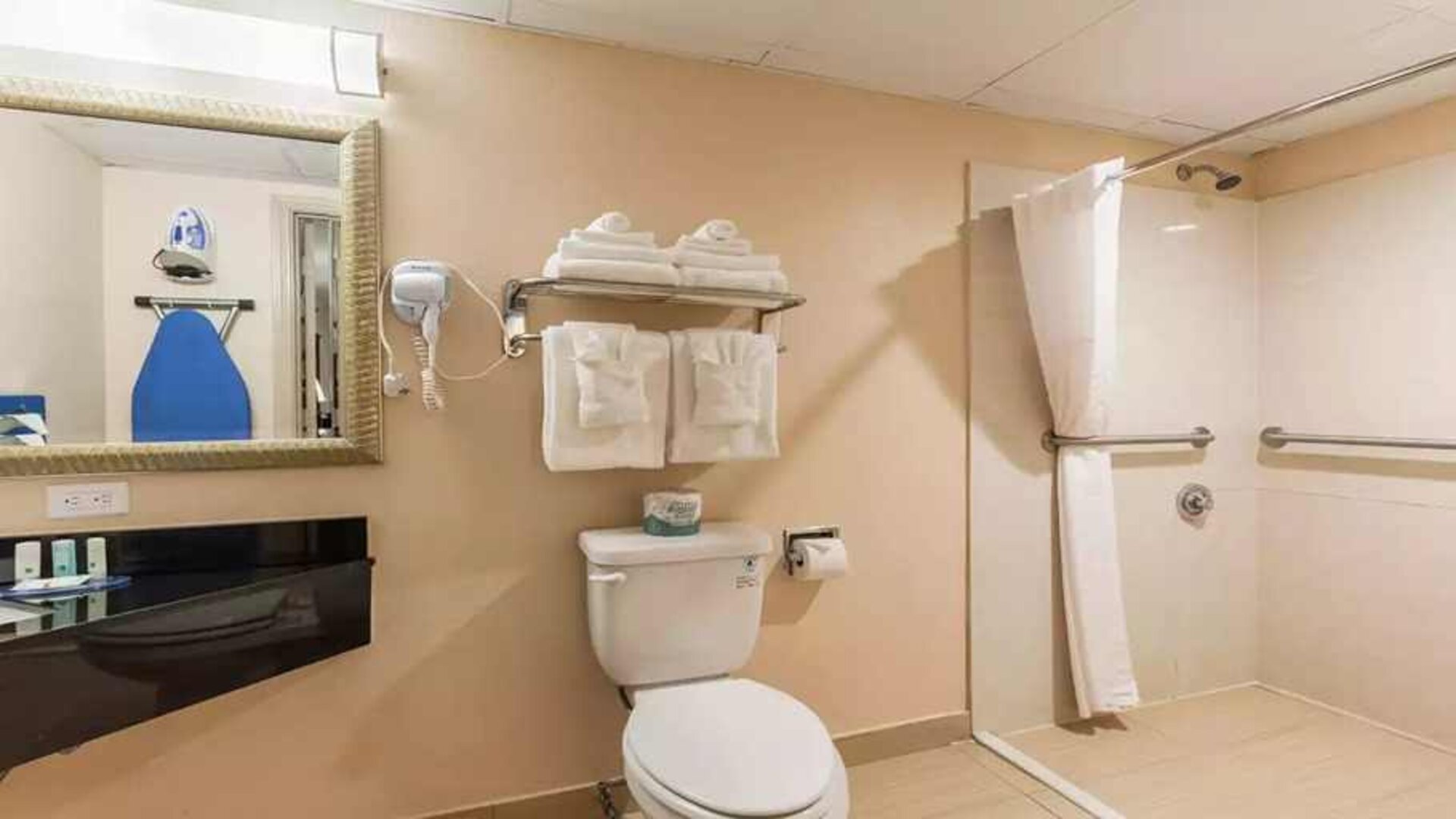 Clean and spacious guest bathroom with shower at Quality Inn Pasadena.