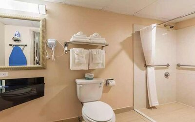 Clean and spacious guest bathroom with shower at Quality Inn Pasadena.
