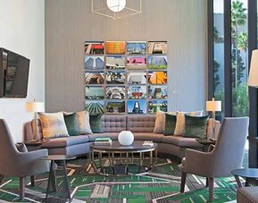 Lobby and coworking lounge at H Hotel Los Angeles, Curio Collection By Hilton.
