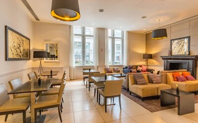 Several tables and upright chairs for laptop work as well as couches for more comfortable leisure sitting and meetings.