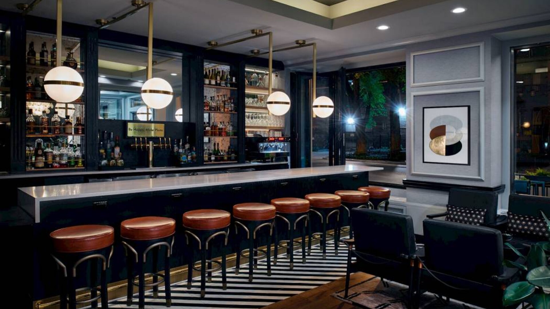 The hotel’s bar, with wide range of liquid refreshments and tall bar stools, as well as tables and chairs.