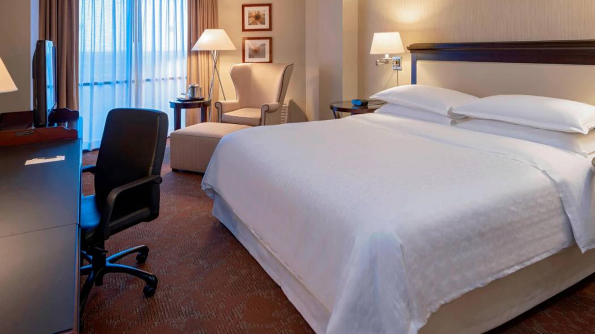Sheraton Houston Brookhollow Hotel guest room with double bed and a workspace desk and chair.