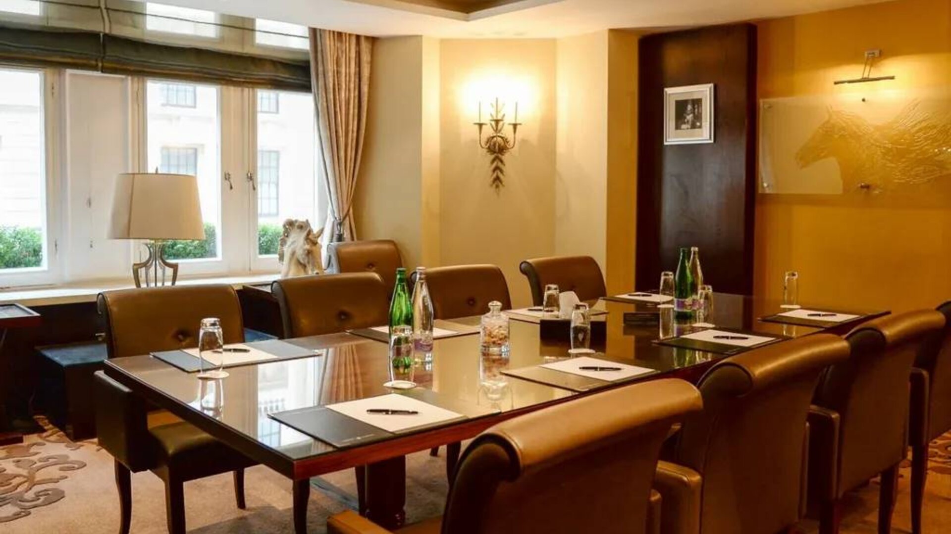 Well-lit boardroom meeting venue with space for around ten people.