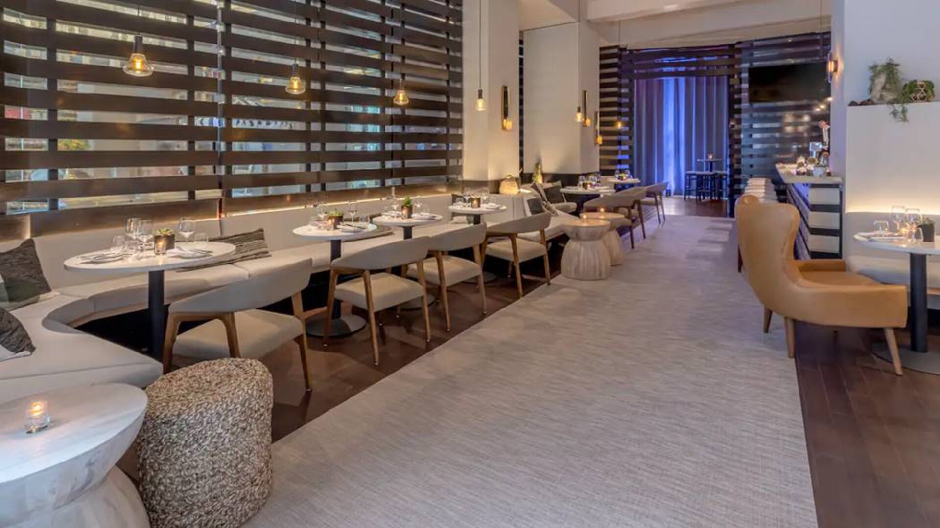 The hotel’s lobby bar, with mix of tall stools at the bar and soft seats around tables.