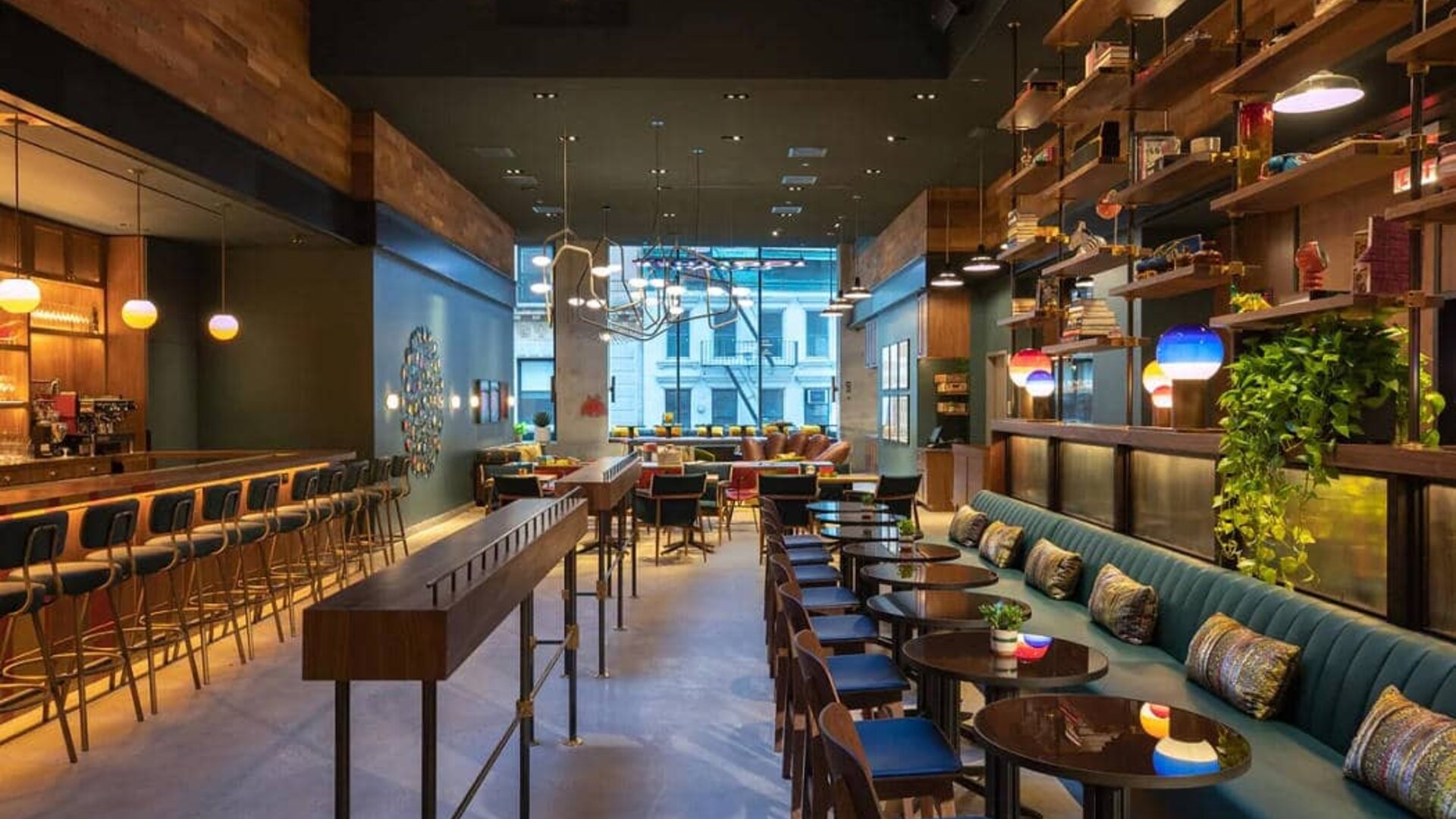 Moxy NYC Downtown’s Recreation restaurant, which has small tables and bar stool seating.