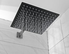 Guest bathroom with shower at Hotel Opus Bronx.