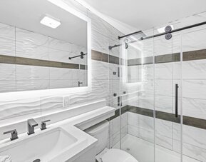 Guest bathroom with shower at Hotel Opus Bronx.