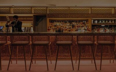 The hotel’s on-site Japanese restaurant, located on the roof, with tall bar stools and omakase-style dining.