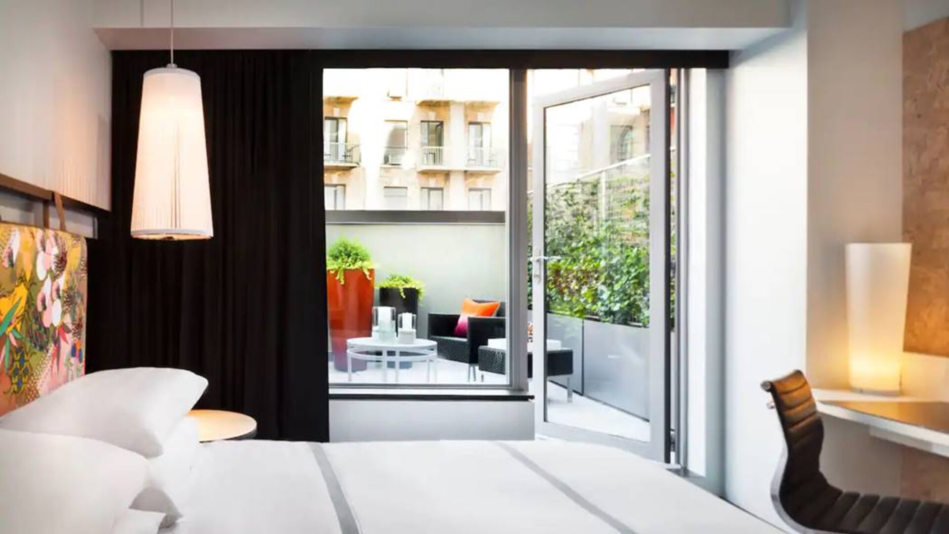 King bed terrace room in the Hyatt Union Square New York, with outdoor lounge area.