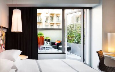 King bed terrace room in the Hyatt Union Square New York, with outdoor lounge area.