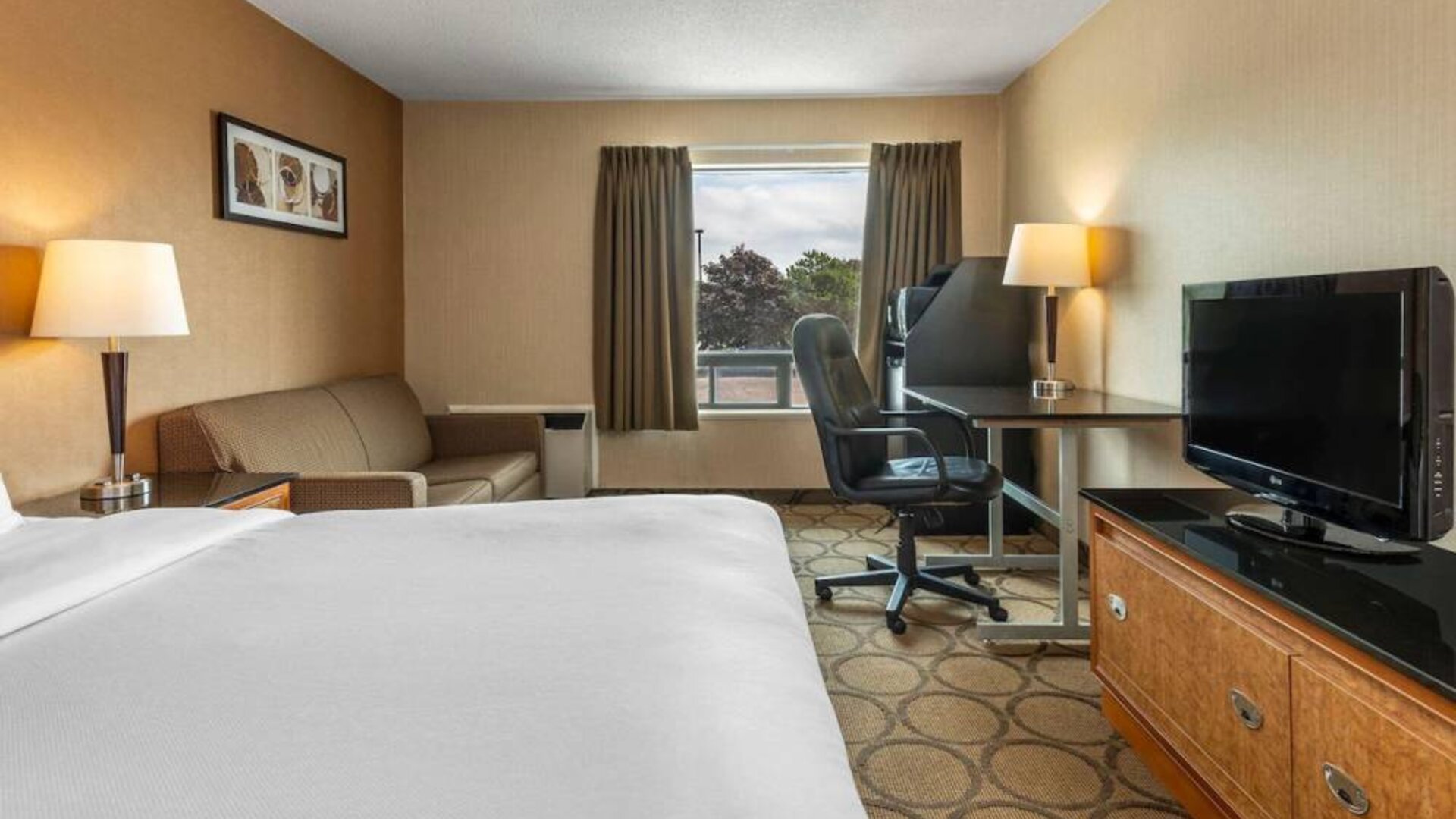 Guest room in Comfort Inn Belleville, with double bed, TV, and window.