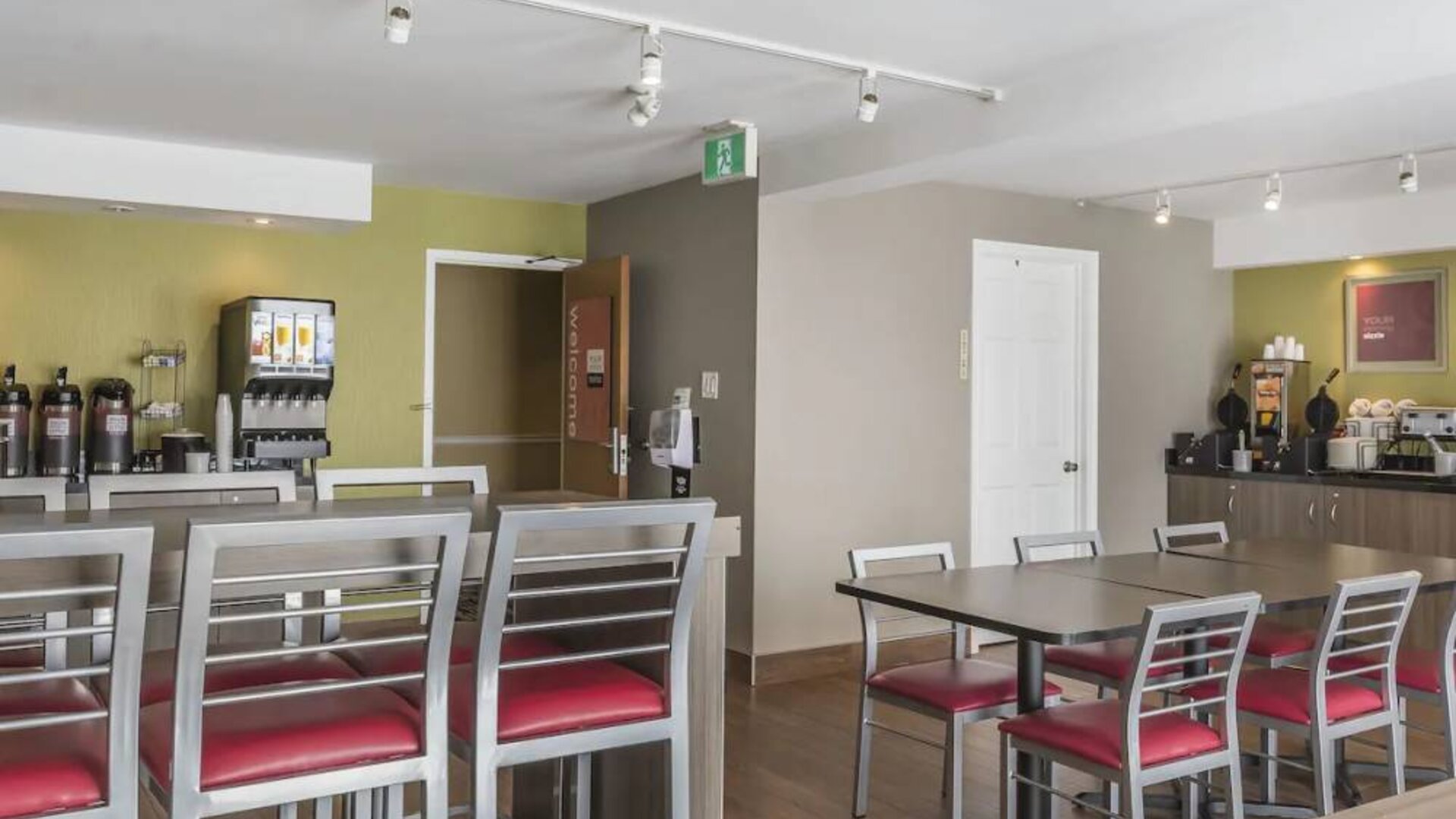 The hotel breakfast area has tall and standard chairs, and a wide range of breakfast fare.