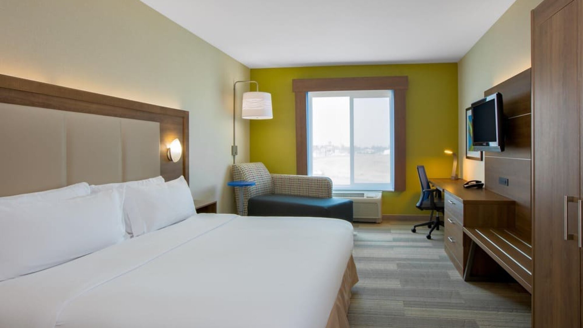 Spacious delux king room with TV and work desk at Holiday Inn Express & Suites Ontario.