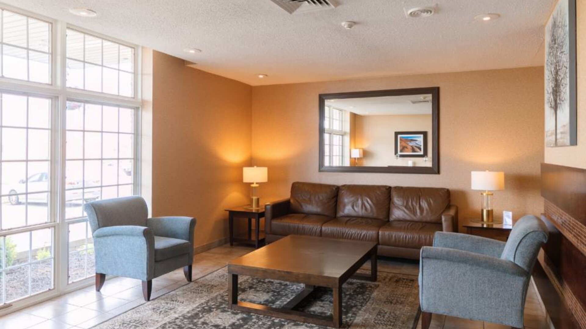 Comfortable seating area in the hotel lobby, with lamps and coffee tables.