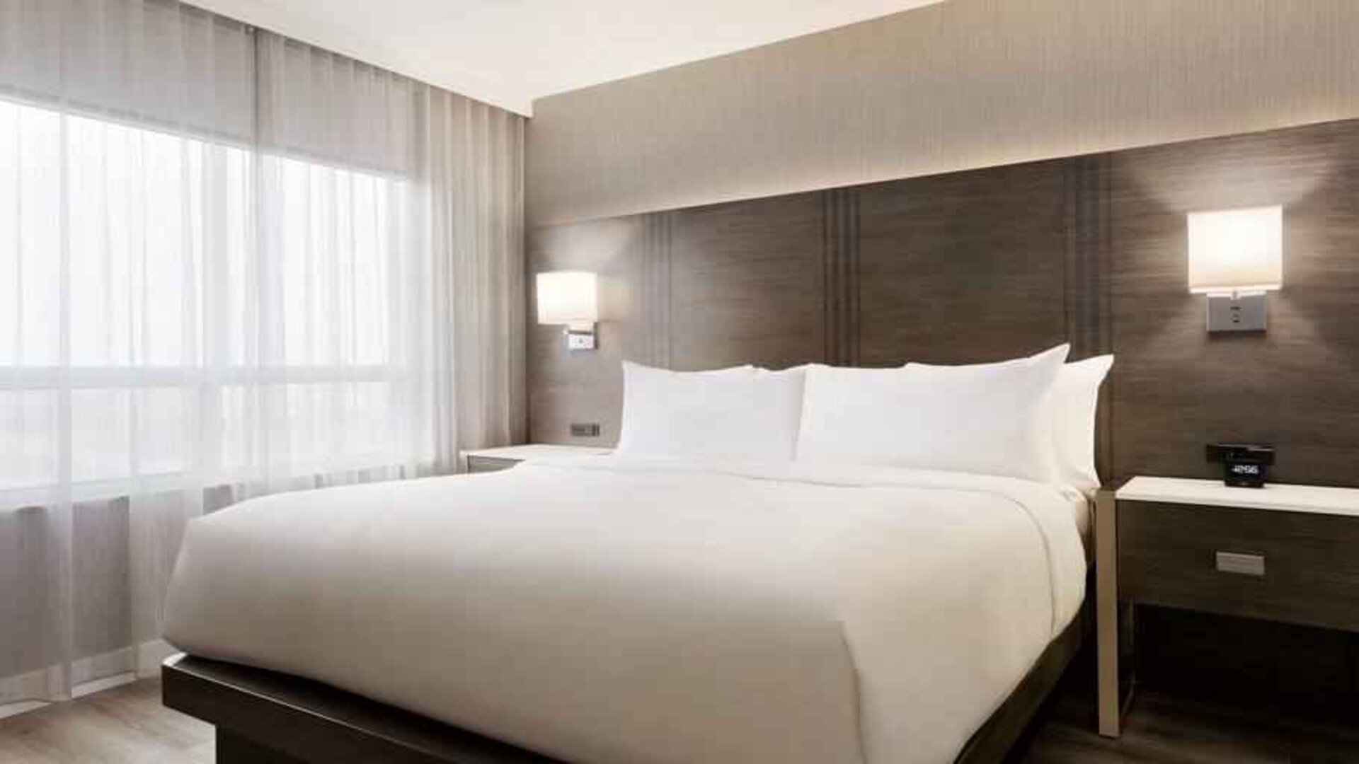 King size bed in a king suite at the Embassy Suites by Hilton Toronto Airport.